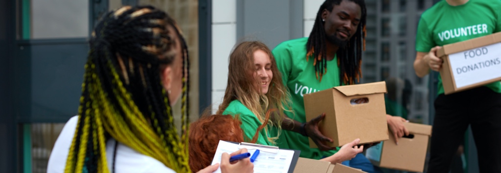 Volunteers passing boxes of food to stock the local food bank