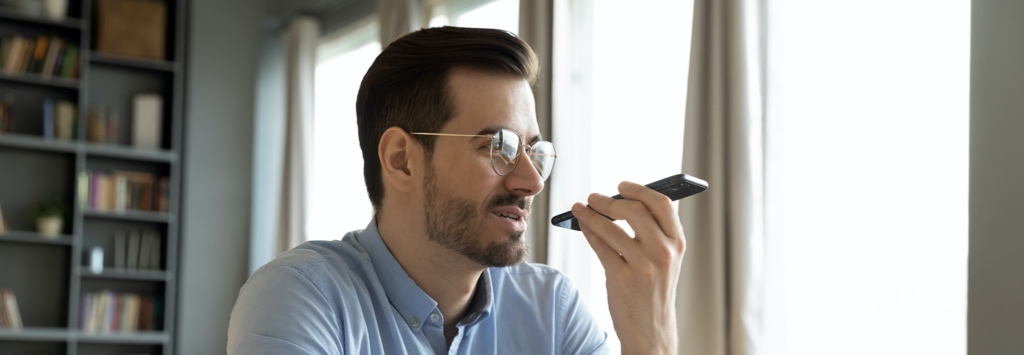 Man sending text message using voice to text technology