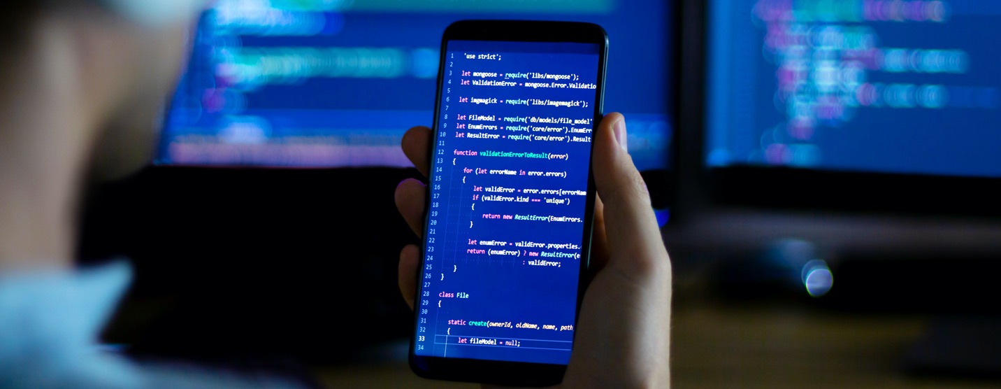 Close up of developer reviewing code on her mobile device