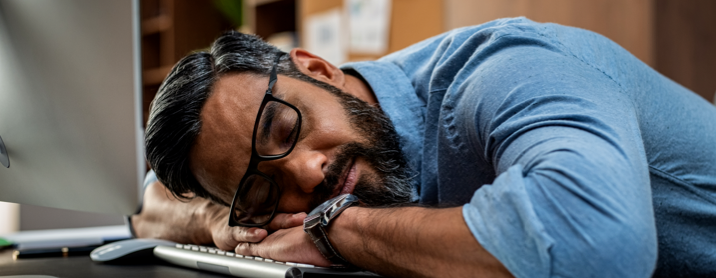 Bearded man asleep on his keyboard 