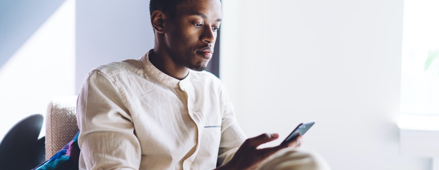 Young man checking email on his phone