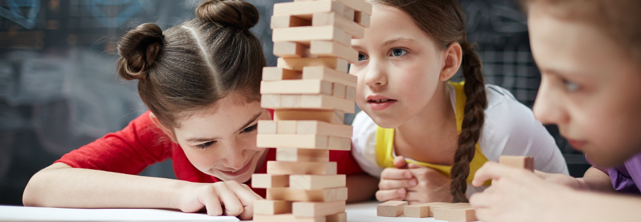 Young students playing Jenga