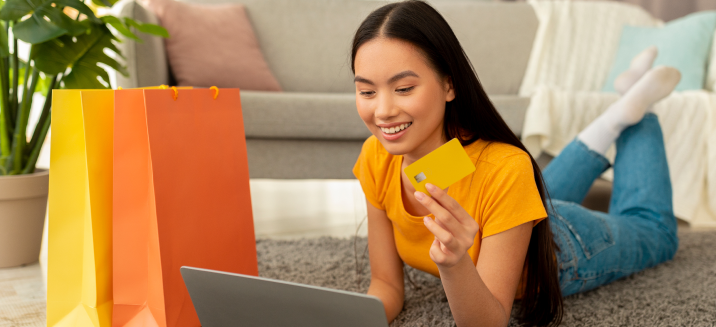 Young woman shopping for clothes on her laptop