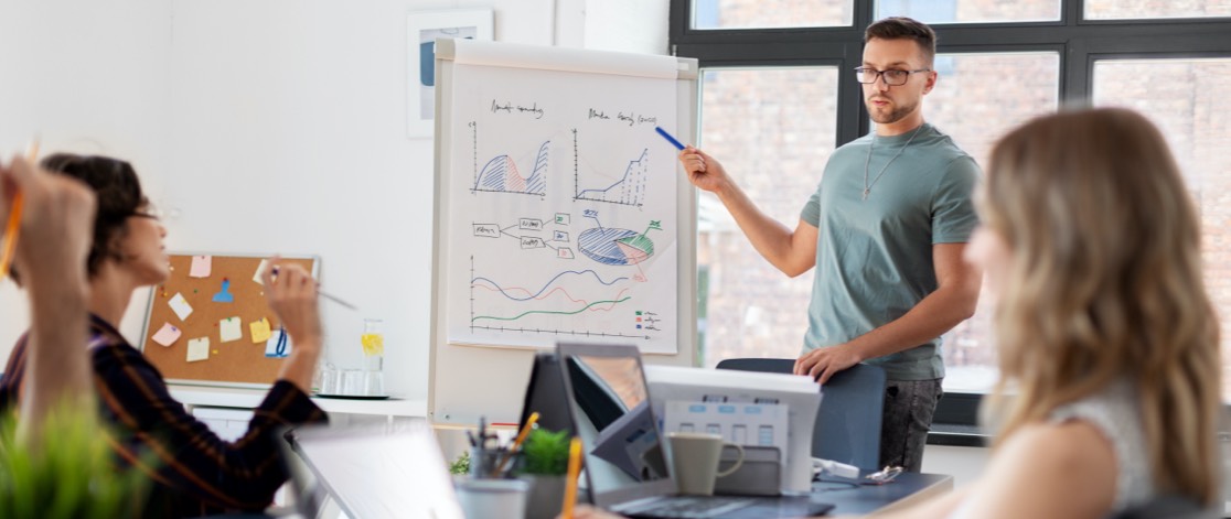 Man presenting analytic data to business team