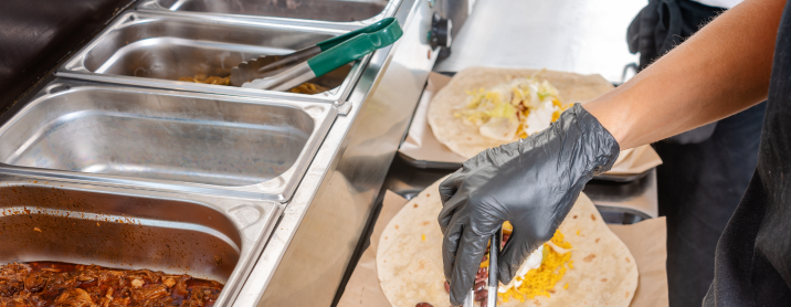 Image of burrito artist making different burrito for customers