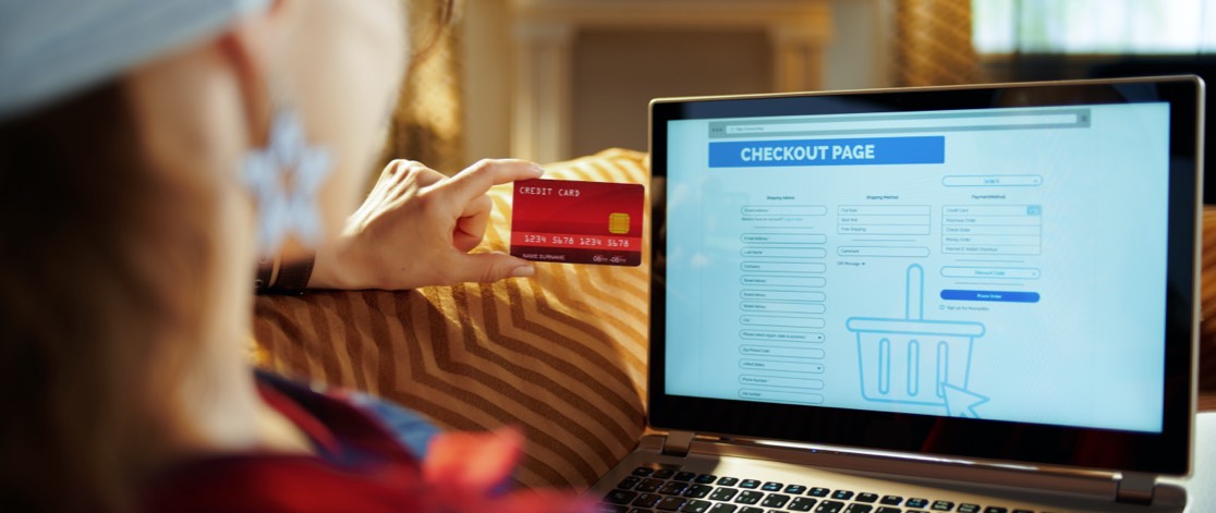 Woman entering credit card details while shopping online 