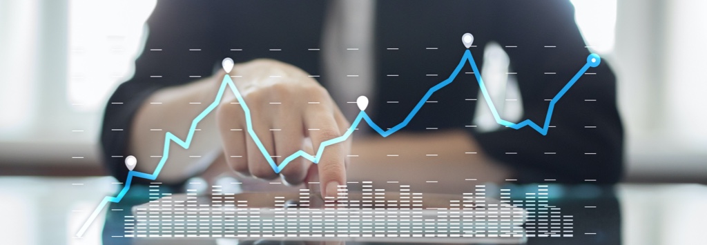 Man at desk with growth chart graphic overlaid