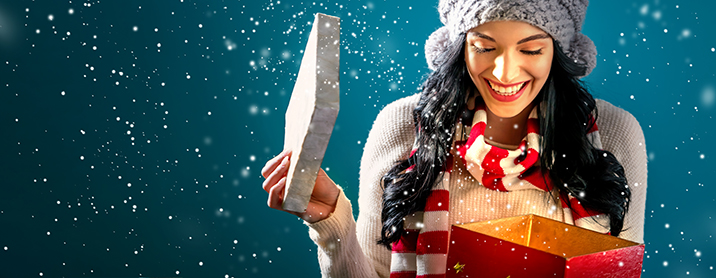 Exciting Young Woman Opening Shiny Present