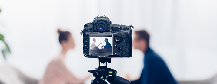 Camera focused on two people sitting down for an interview