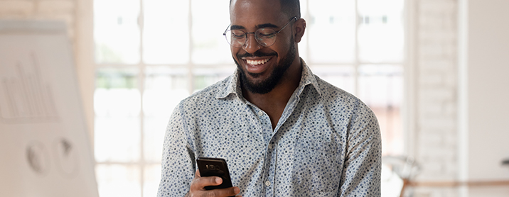 Man happy while checking email on his phone