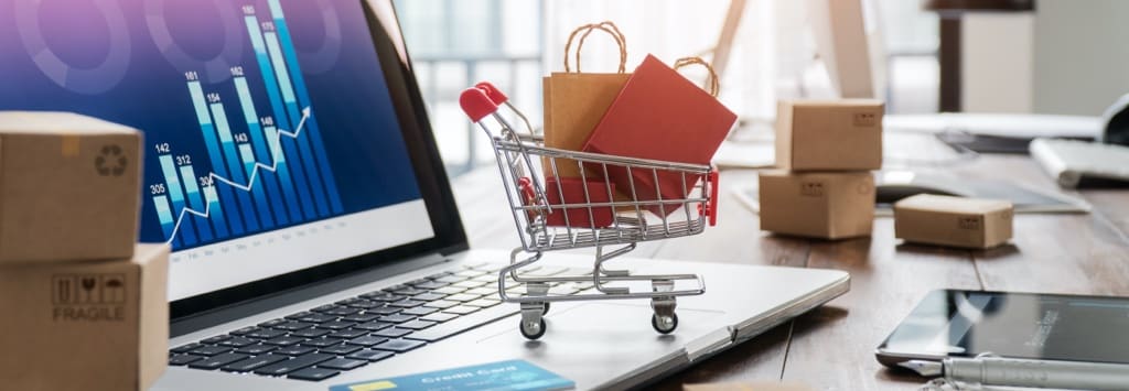 Toy Shopping Cart on Top of Laptop Keyboard