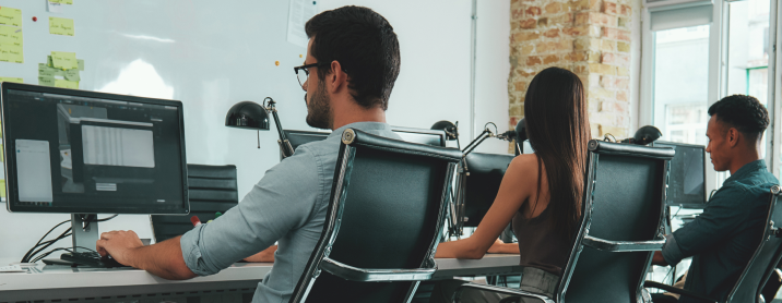 Group of diverse engineers working in an open floorplan office