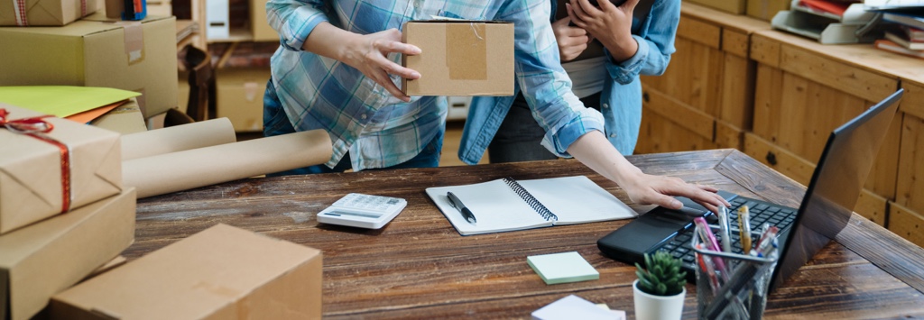 Two young retailers preparing orders for shipment