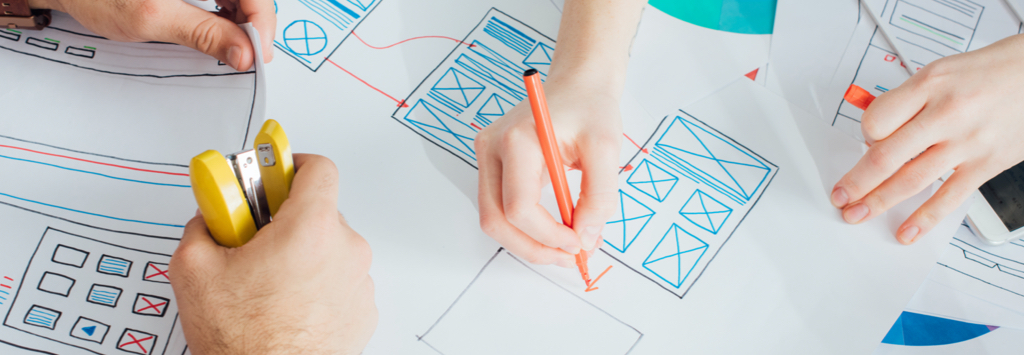 UX Designers sketching out wireframes of mobile website