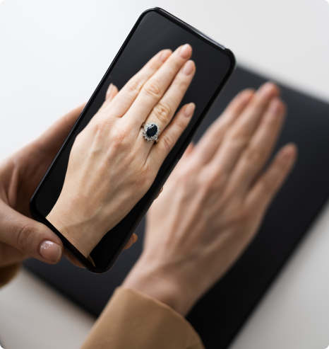 Woman trying on a ring using Augmented Reality on her mobile phone