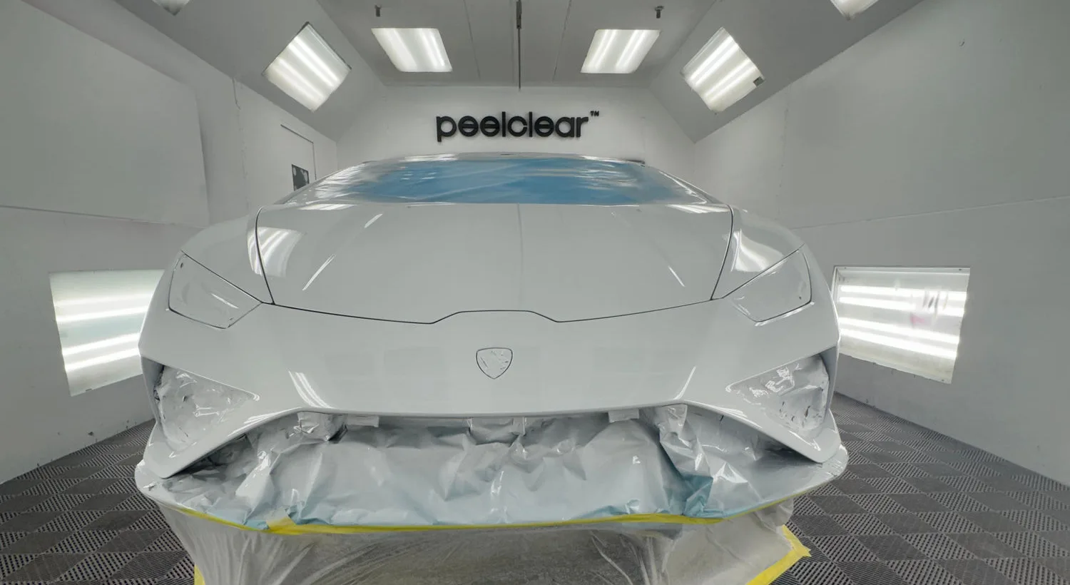 White Lamborghini Huracán in the Peelclear spray booth