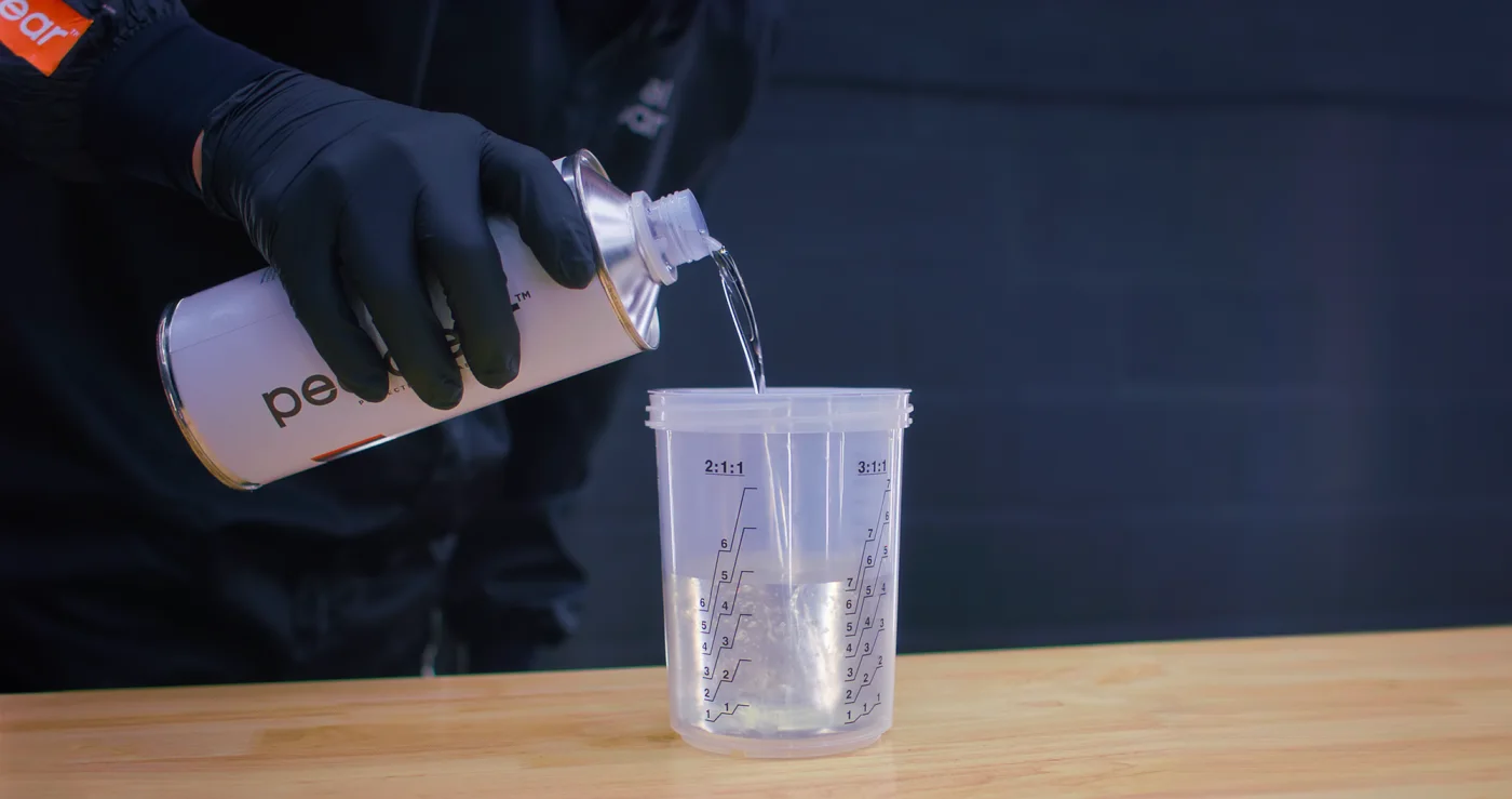 Peelclear waterborne base coat being poured into a mixing cup