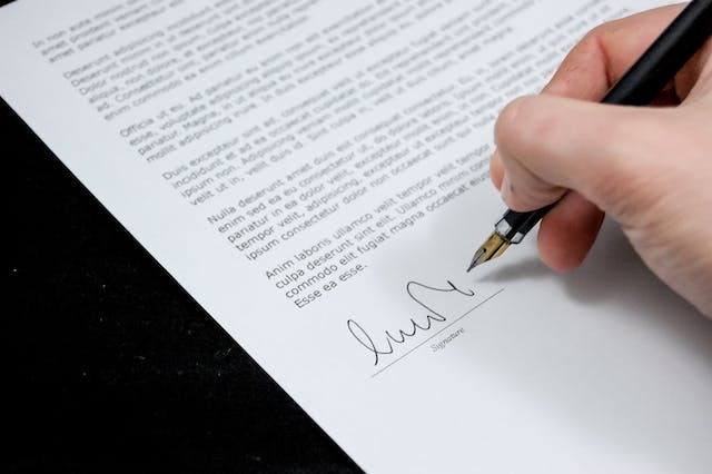 A man signs a document