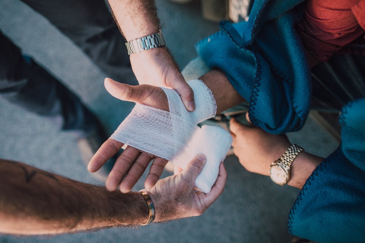 A person's wrist being bandaged