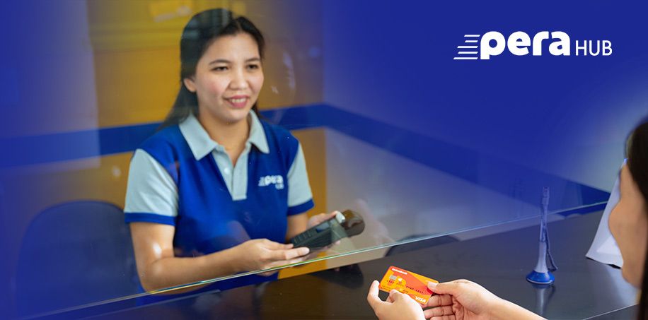 PERA HUB officer holding a card reader ready to process a transaction with a customer holding a UnionBank card