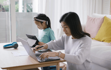 Mother working from home beside her child
