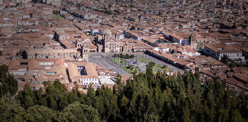 Trees hug the city of Cusco, with its characteristic terracotta roofs and architecture blending Inca and colonial influences