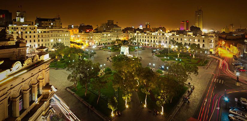 Plaza de Armas of the historic center of Lima Illuminated at night with Peruvian colonial buildings on the perimeter