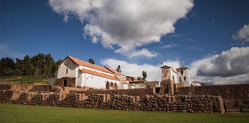 Sacred Valley ruins with colonial structure nestled in the lush greenery of this Andean landscape on a sunny day