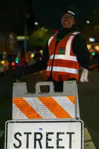 Photograph: Smiling Worker Behind Barricade