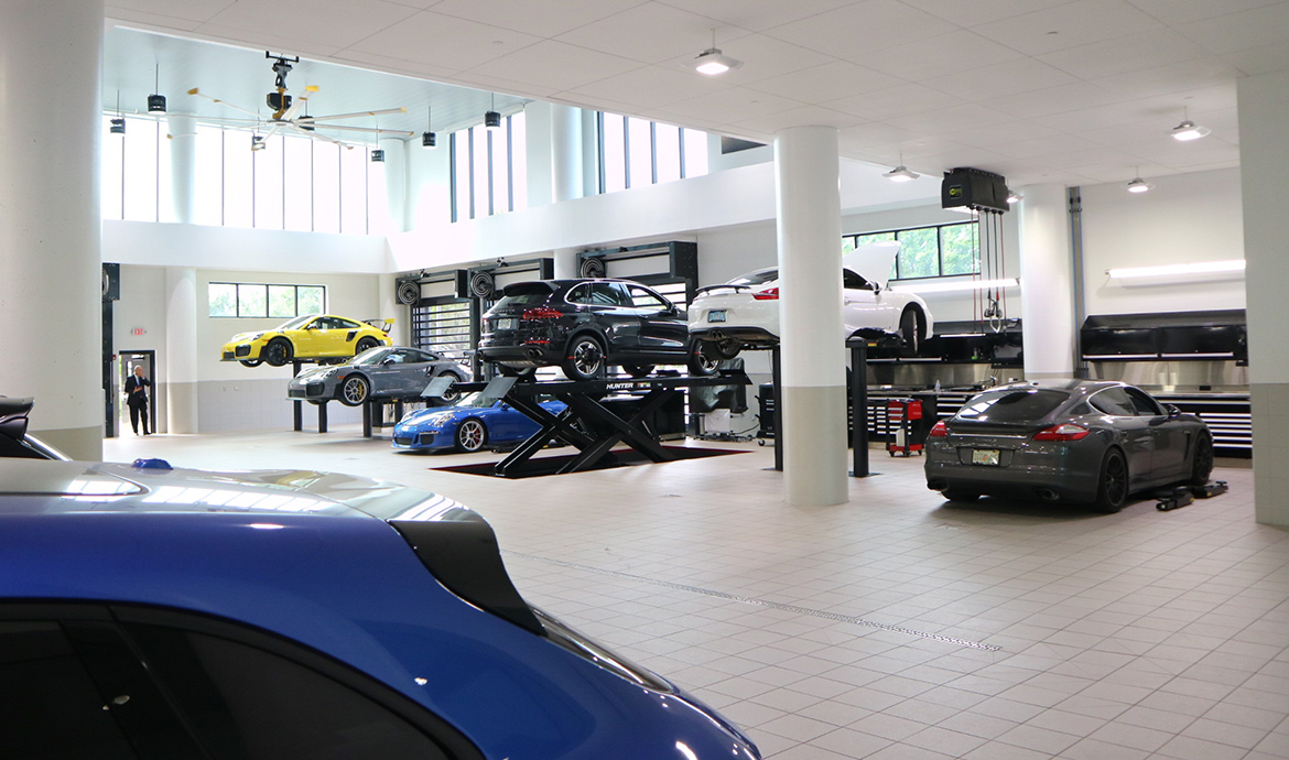 Wide Shot of Porsche vehicles on lifts being serviced at Porsche South Orlando