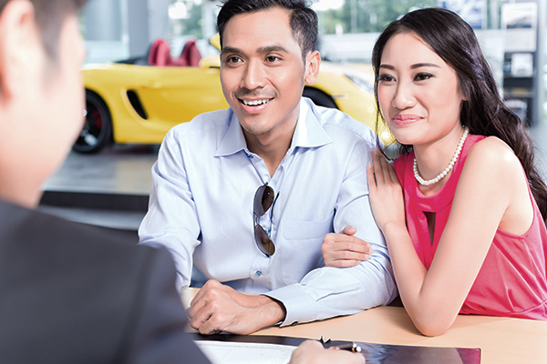 Couple signing paperwork Couple signing paperwork