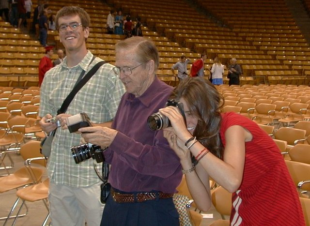 kyle, grandpa logan, and bethany take pictures