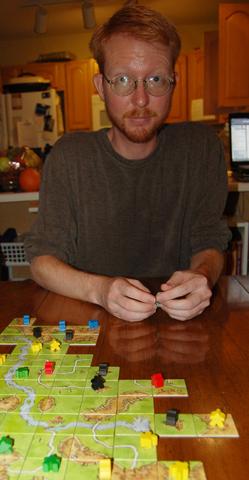 Humblik considers his next Carcassone move