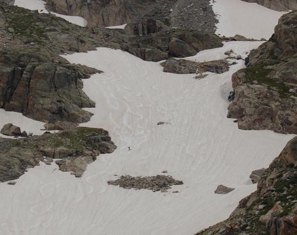 Skier descends snowfield below Apache Peak