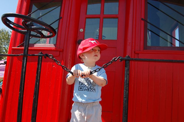 Calvin holds on to the back of a caboose