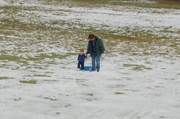 Calvin and Kiesa climb the hill after sledding