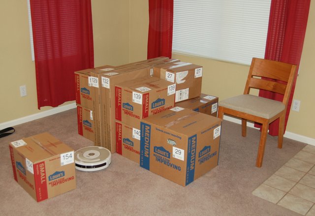 Boxes staging in the living room, waiting to be moved