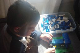 Calvin plays with Legos on the plane to Pasco