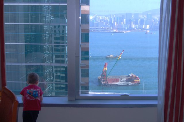 Calvin looks out the hotel window at Victoria Harbour