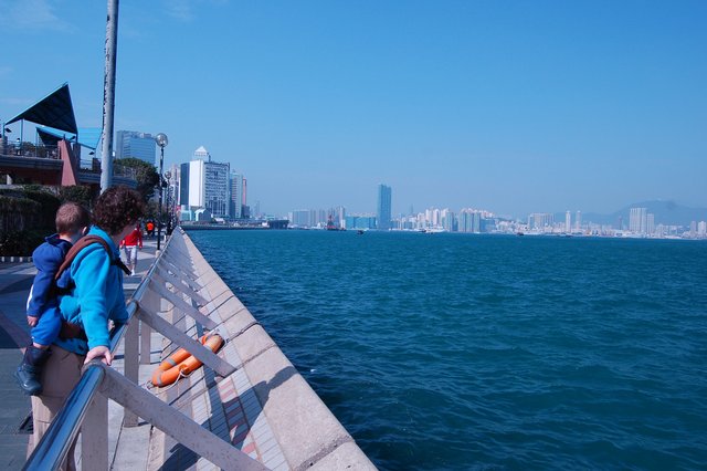 Kiesa and Calvin look out over Victoria Harbour from Quarry Bay