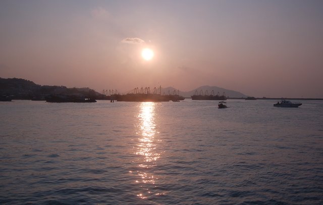 Sun setting over fishing boats in the harbor at Cheung Chau