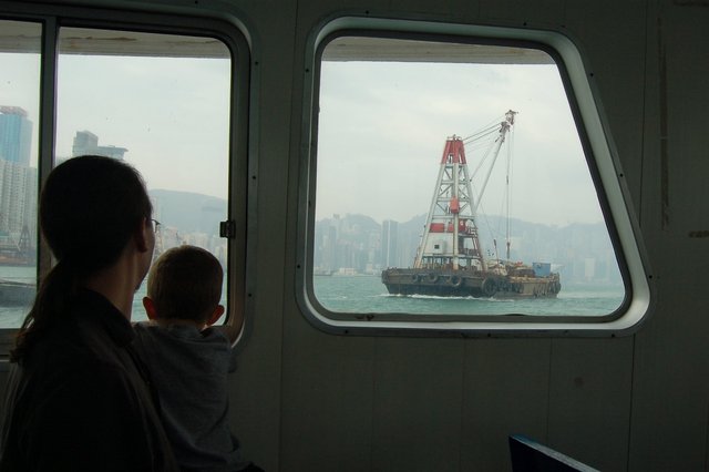 Jaeger and Calvin watch a barge on Victoria Harbour