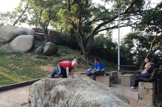 Calvin climbs on a rock while Jaeger consults the guidebook