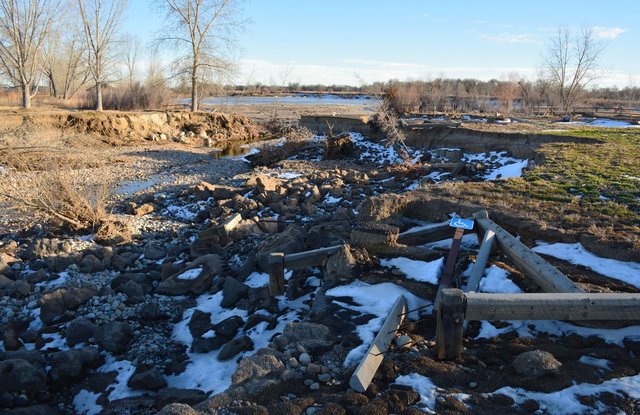 Flood-damaged parking lot at Pella Crossing