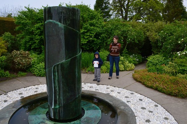Calvin and Kiesa look at the fountain in Cawdor Castle's gardens