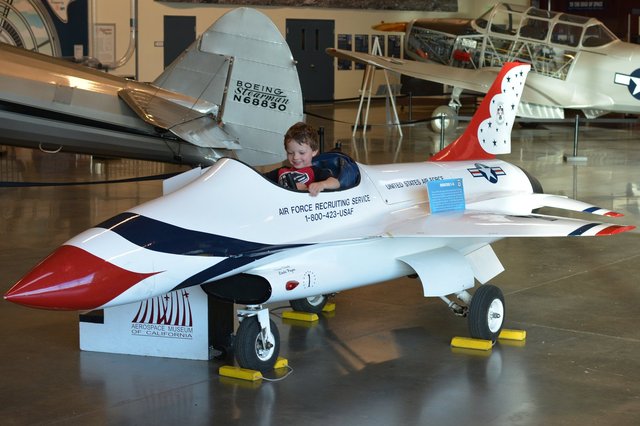 Calvin in an Air Force recruiting F-16 model