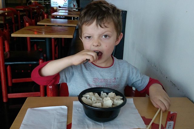 Calvin eats noodle and tofu at DIA