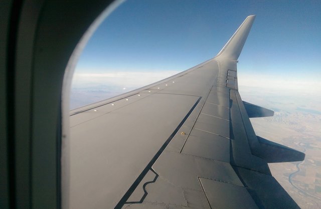 Ivanpah Solar Electric Generating System glinting in the sun over a 737 wing