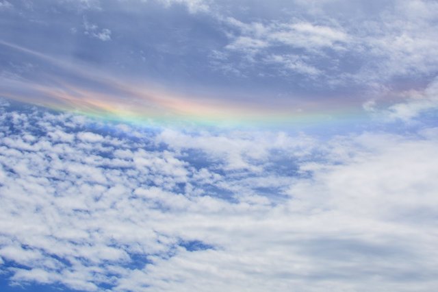 Interstitial rainbow in middle of cloud