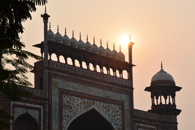 Setting sun behind the entry gate at the Taj Mahal